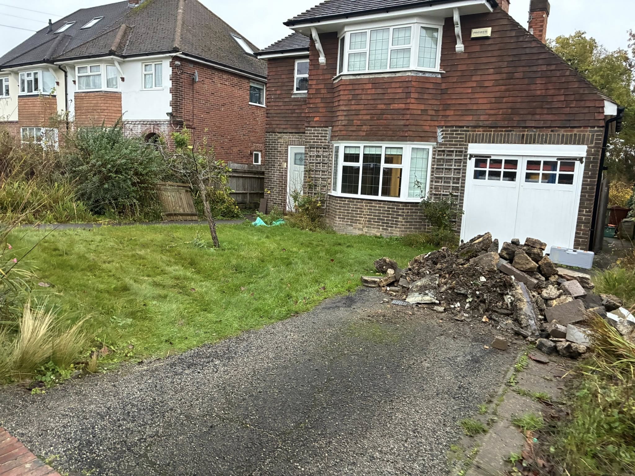 Before: Overgrown front garden with old tarmac and rubble